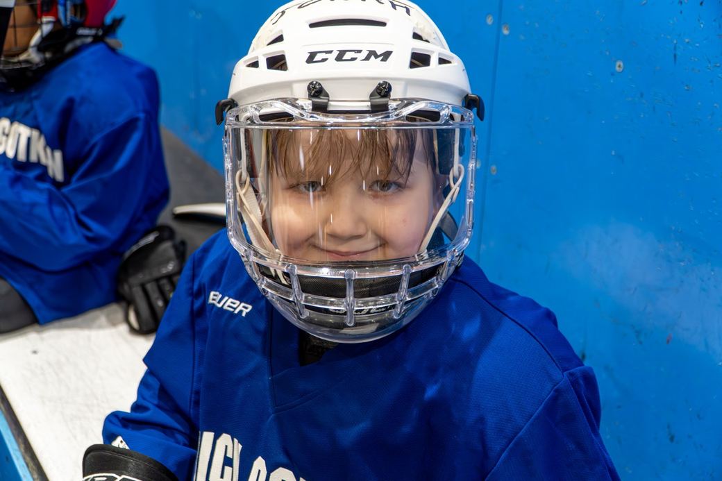 A young camper in blue looking straight down the lens