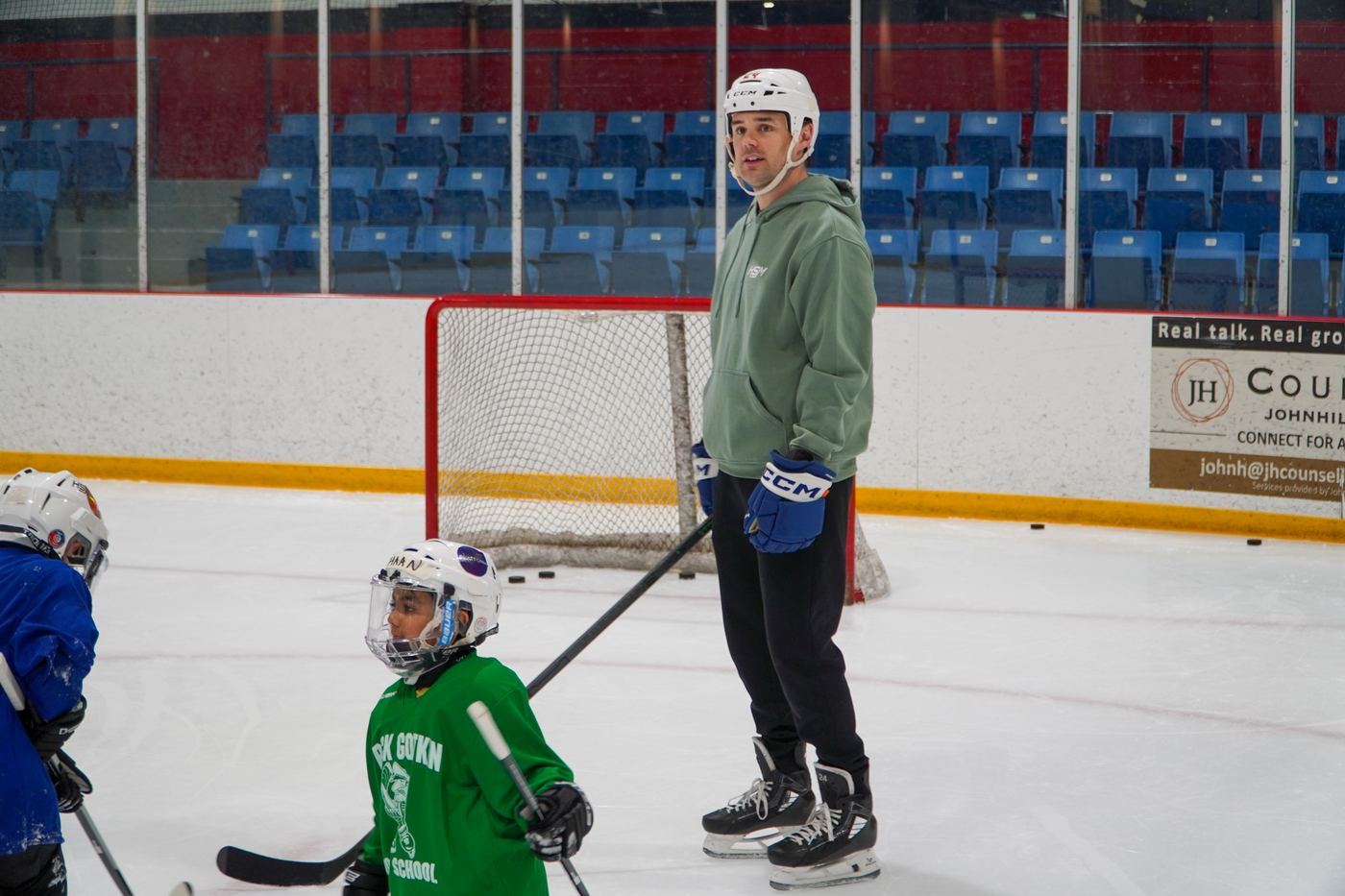 A wide view of the full group during an on-ice drill