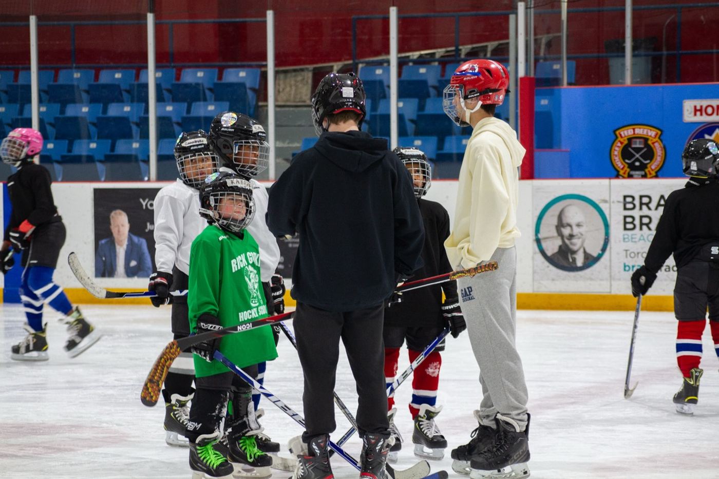 Campers in a long line stretching across the width of the rink