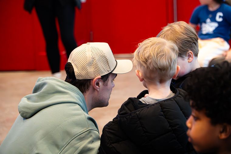 Family members watching a session from the arena seating