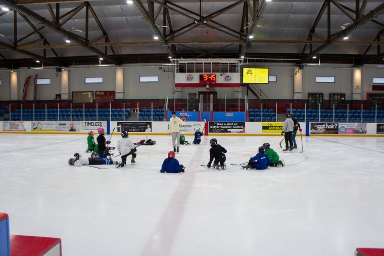 A wide view of Ted Reeve Community Arena with campers spread across the ice