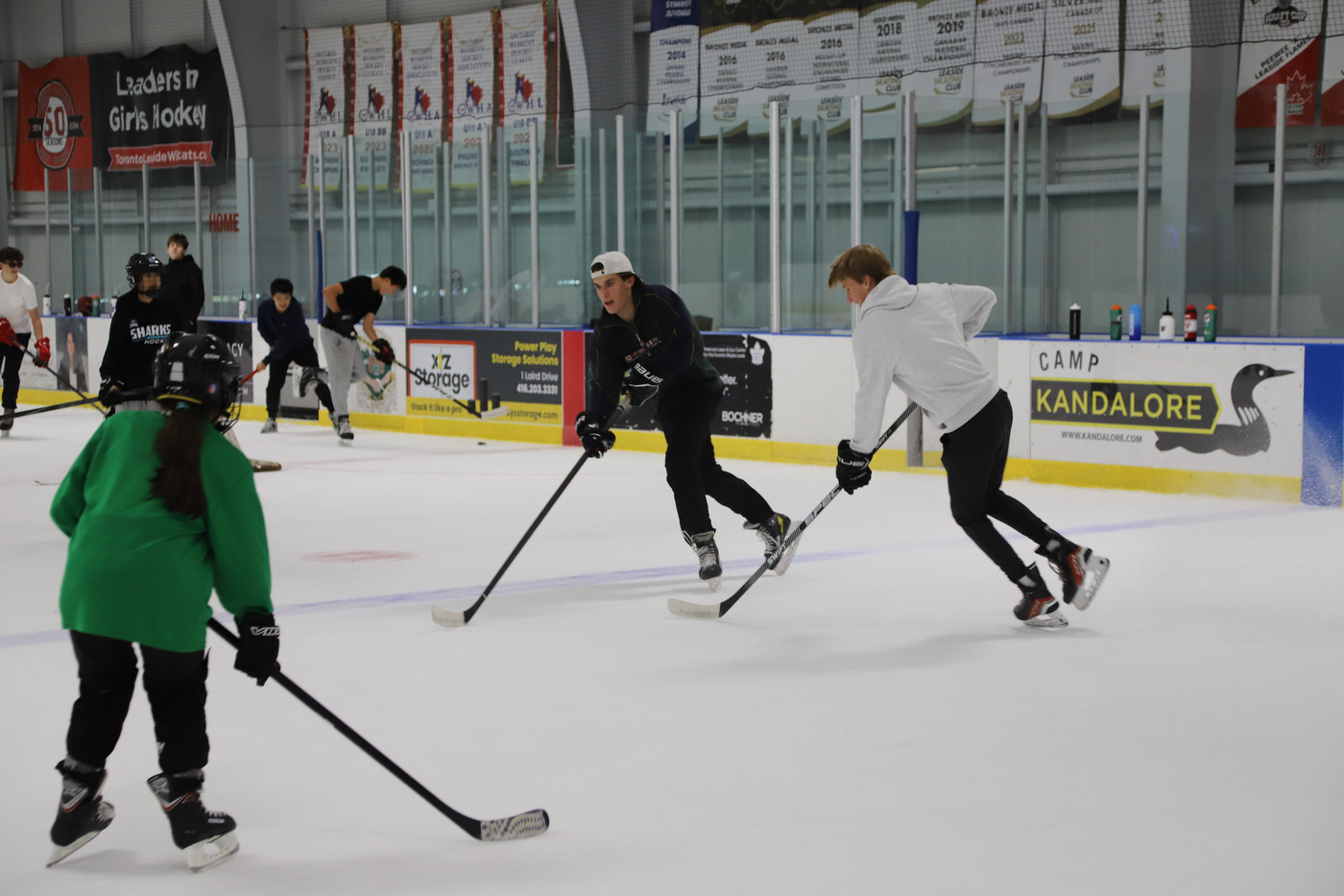 Campers and volunteers carrying the puck up the ice on the third day